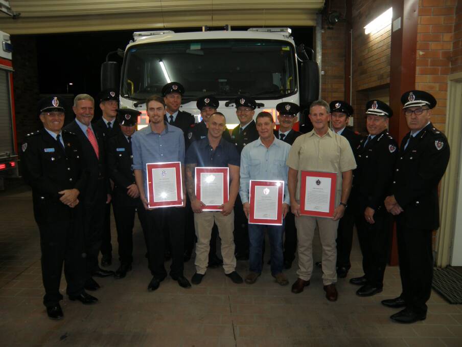 Jackson Ludlow, Jamie Fitzroy, Steve Smith and Brian Jaeger receive bravery awards for rescuing two people from a fire in February last year. They are pictured with Gunnedah Fire Station commander Rod Byrnes, Gunnedah mayor Owen Hasler, Richard Patriquin, Brock Stone, David Welch, Sam Turner, Paul Hartley, David Moses, Daniel Poss, superintendent Tom Cooper zone commander regional north three, and inspector Wayne  Zikan duty commander regional north three.  Picture: Denise Hartley
