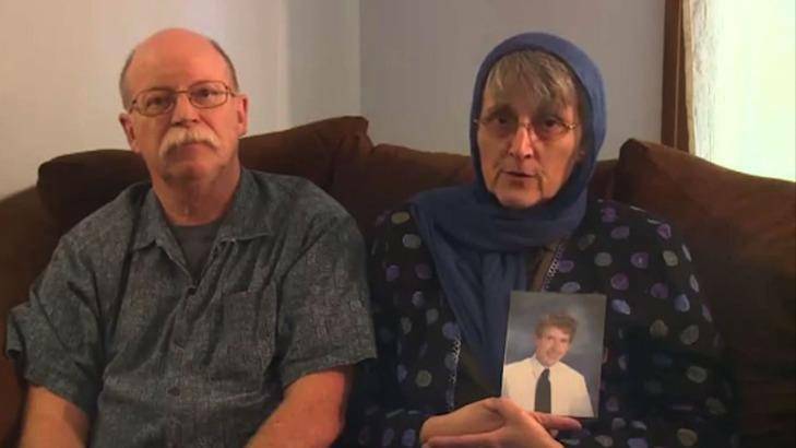 Ed and Paula Kassig with their son's portrait in an earlier video plea for his safe return.