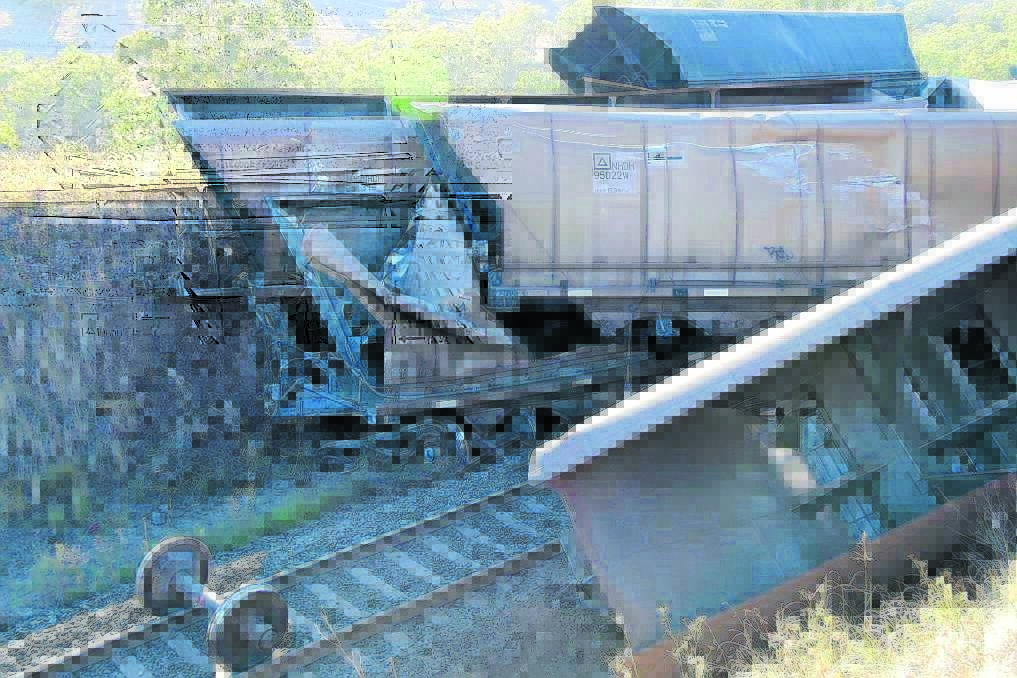 INVESTIGATION: The derailment badly damaged the train line at Kankool and forced its closure for almost a week.