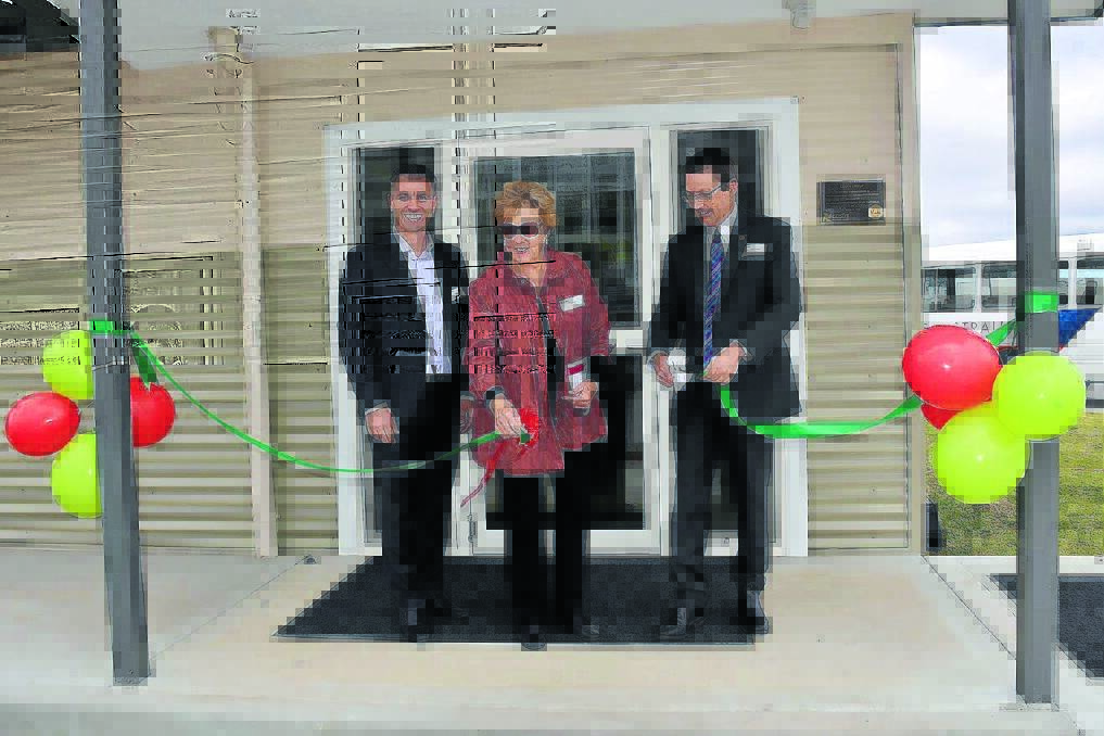 RED RIBBON: Cutting the opening ribbon is Costa chief operating officer George Haggar, former mayor Robyn Jackson and former Guyra resident and MLC Scot MacDonald. Photo: Janelle Stewart