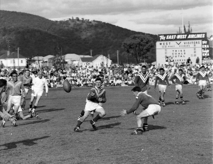 Boggabri captain-coach and half Barry Kellam fires a pass away to centre Robert Heiler before West centre Ken Thompson can effect the tackle. Others in the picture include (from left) Boggabri five-eighth Bill Robinson, prop Michael Nelson, referee Ted McAlpine, West hooker Denny Dewhurst (behind Kellam), prop Fred Mitchell, second-rower and coach Brian Fletcher, five-eighth Bill Walton and lock Harry Marcellos.