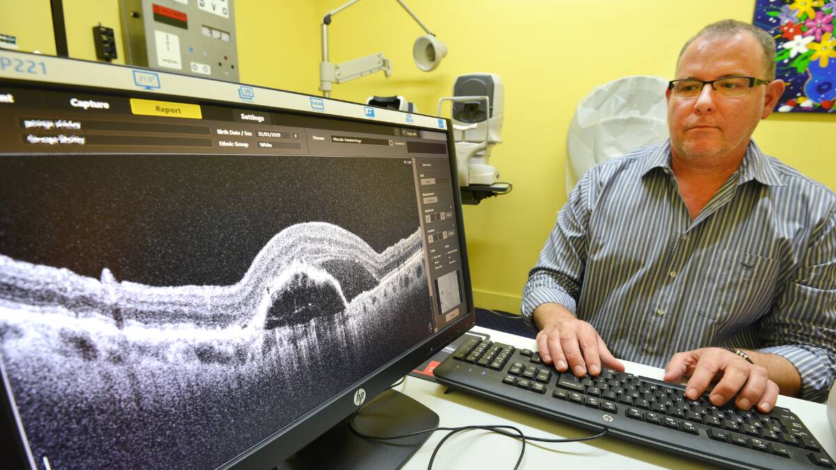 STARK IMAGE: Tamworth optometrist Andrew Greer examines a case of macular degeneration.  Photo: Barry Smith 170516BSC02