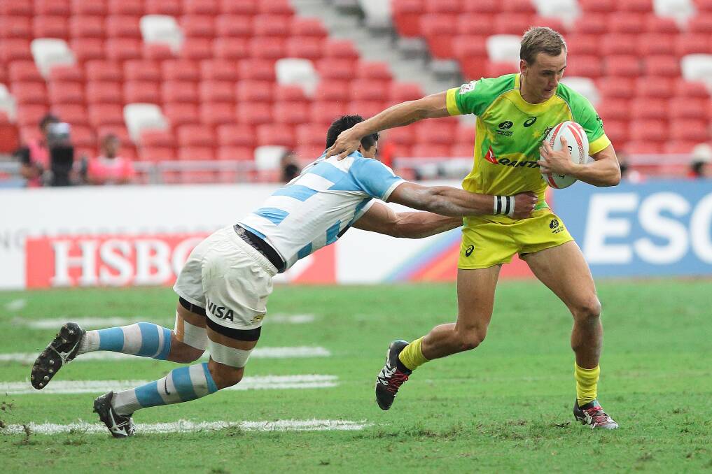 John Porch, here trying to escape the clutches of Argentina’s Axel Muller during this year’s Singapore Sevens, was yesterday named in the men’s sevens Olympic squad. Photo:  Suhaimi Abdullah/Getty Images.