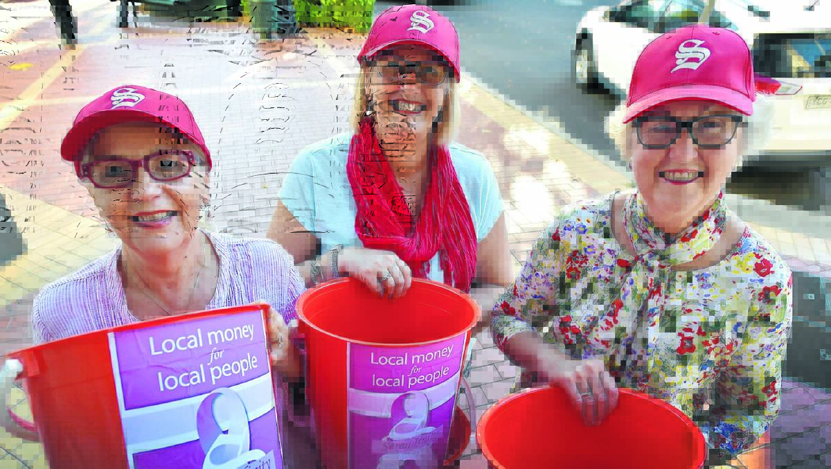 LADIES IN RED: Sandy Brooks, Liney Manning and Adele Holtsbaum out collecting for Red Bucket Day. Photo: Geoff O’Neill 030516GOF01