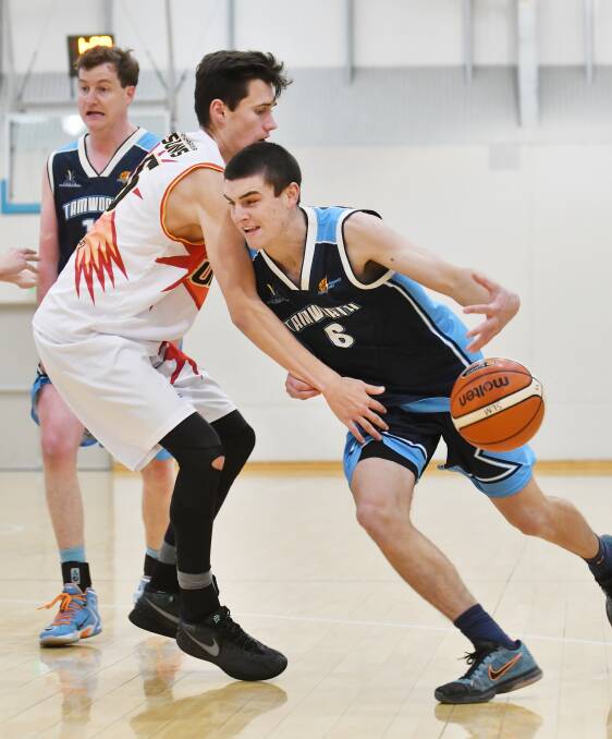 Young Thunderbolt guard Max Chillingworth drives to the basket against Coffs Harbour Suns earlier this season as skipper David Bourke (left) sets a screen. Photo: Barry Smith 260616BSD08