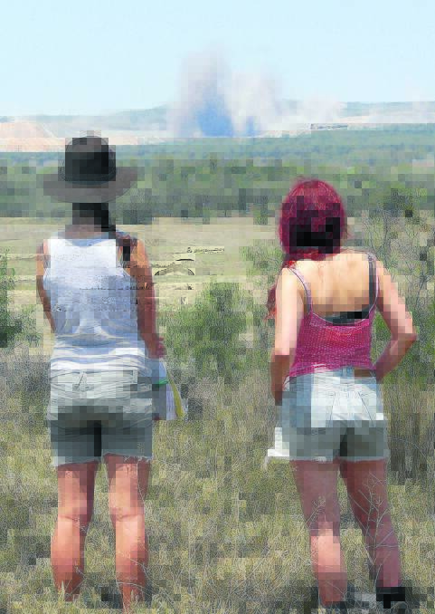 DUST DEBATE: Leard Forest Research Node members watch the dust from a mine blast at a vantage point on Pat Murphy’s property.