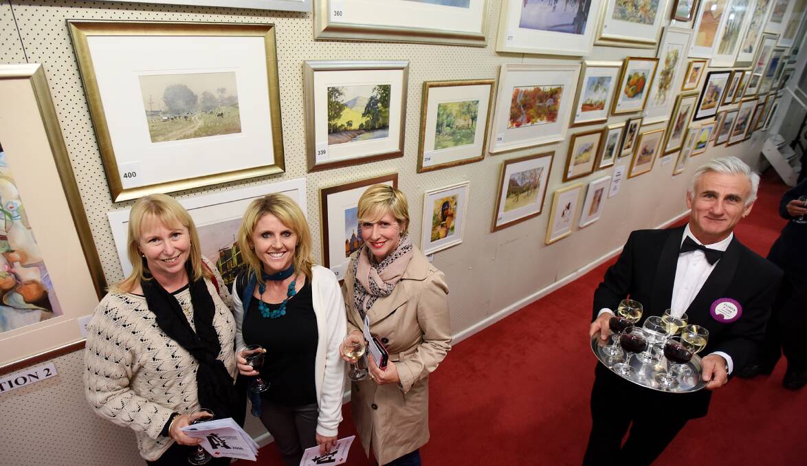 ART SHOW OPENING: Arts lovers Kate Cullen, Kathy Neill and Simone Lewin from Tamworth with Lions Club member Patrick Long as waiter. Photo: Gareth Gardner 120516GGE22