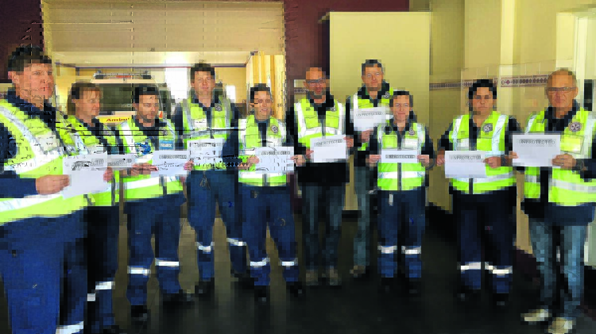 CALL TO ARMS: Tamworth paramedics, pictured with Health Services Union New England Sub-branch president Dave Lucietto, centre, during the recent silent protest.
Photo: Breanna Chillingworth