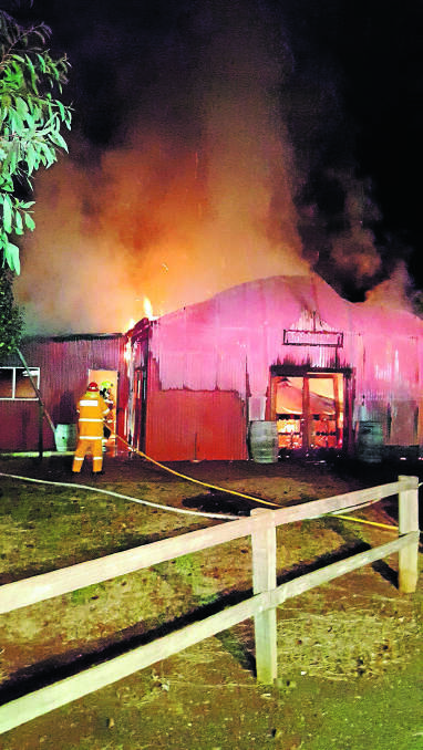 UP IN FLAMES: Firefighters were able to stop the blaze from spreading to the nearby wine storage area but the cellar door was destroyed. Photo: Nigel Sharman