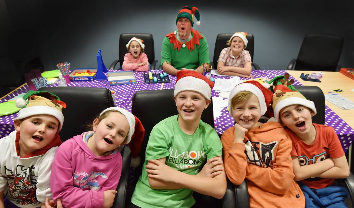 PREPARING OUR KIDS:  It was Christmas in July and a little learning, too, for Blake and Maddison Mabbott, Riley Givney,  Flynn Andrews and Ashton Edmonds and at back, Anameika, Craig and Bryn McLeod. Photo: Barry Smith 150716BSE02