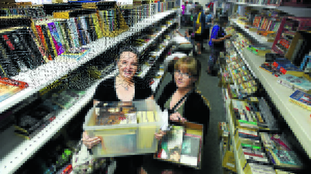 LOTS TO READ: Happy readers, sisters Stacey Allen and April Cowan, were happy to box book bargains at the sale. Photos: Gareth Gardner 300416GGA01