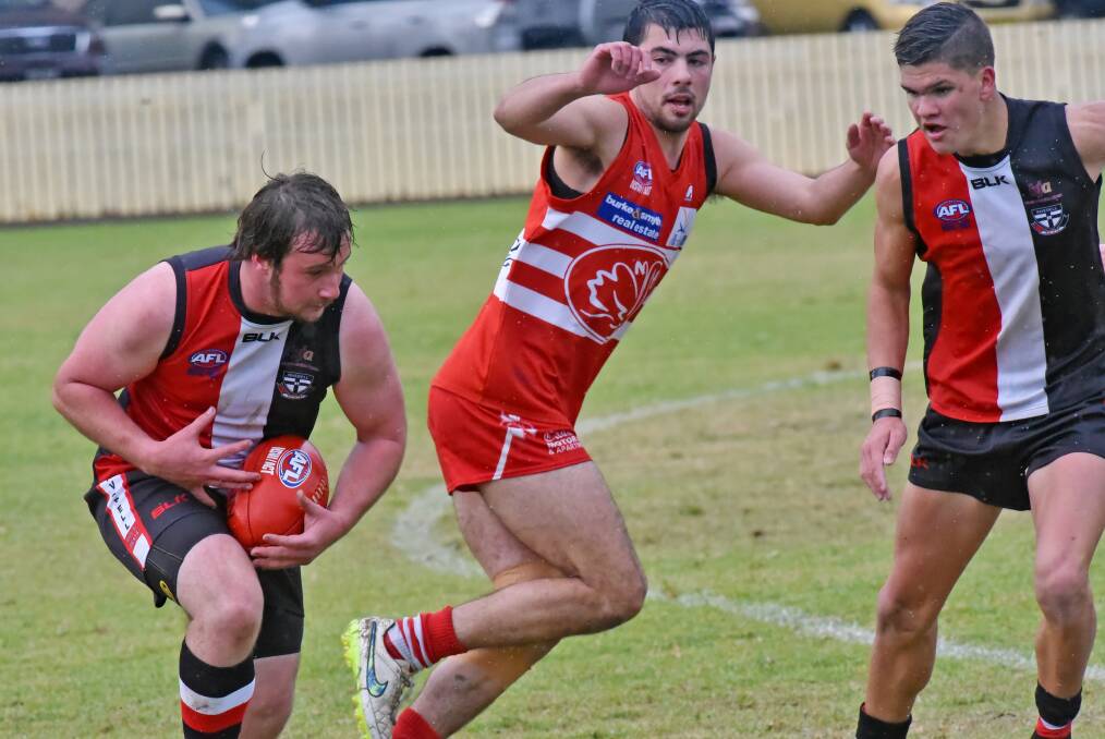 Big Beau Coles takes possession for the Saints against Tamworth Swan Nathan Keam. Coles kicked a goal in his side’s 43-point win at No 1 Oval on Saturday. Photo: Geoff O’Neill 280516GOE06