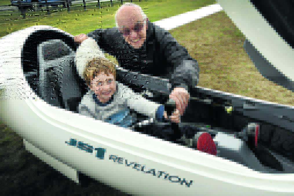 LITTLE PILOT: Six-year-old Elijah Philp checks out a glider with Chris Bowman from Lake Keepit Soaring Club, as the club promotes the sport of gliding and its membership initiatives. Photo: Geoff O’Neill 280516GOA01