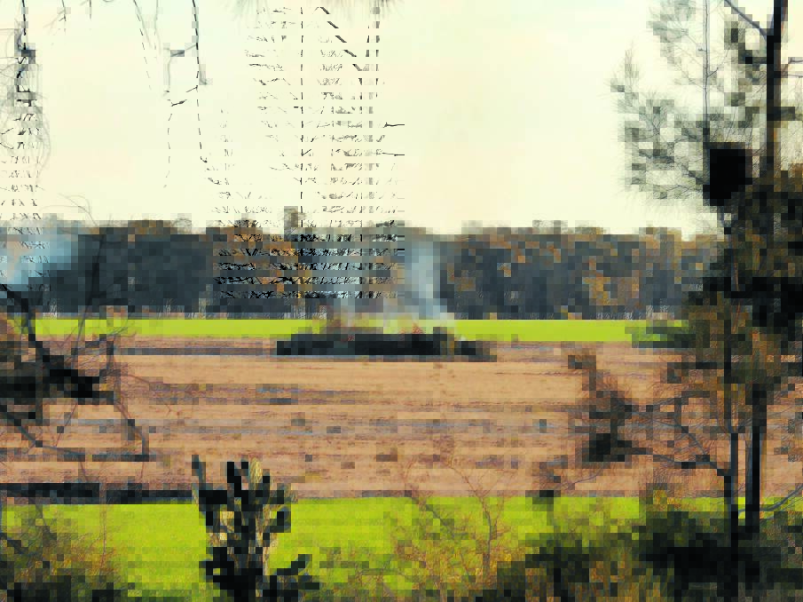 TRIAL EXHIBIT: One of the photos of stacks of native vegetation burning on a property, taken by OEH officer Robert Strange in Croppa Creek just before the killing. Photo: supplied