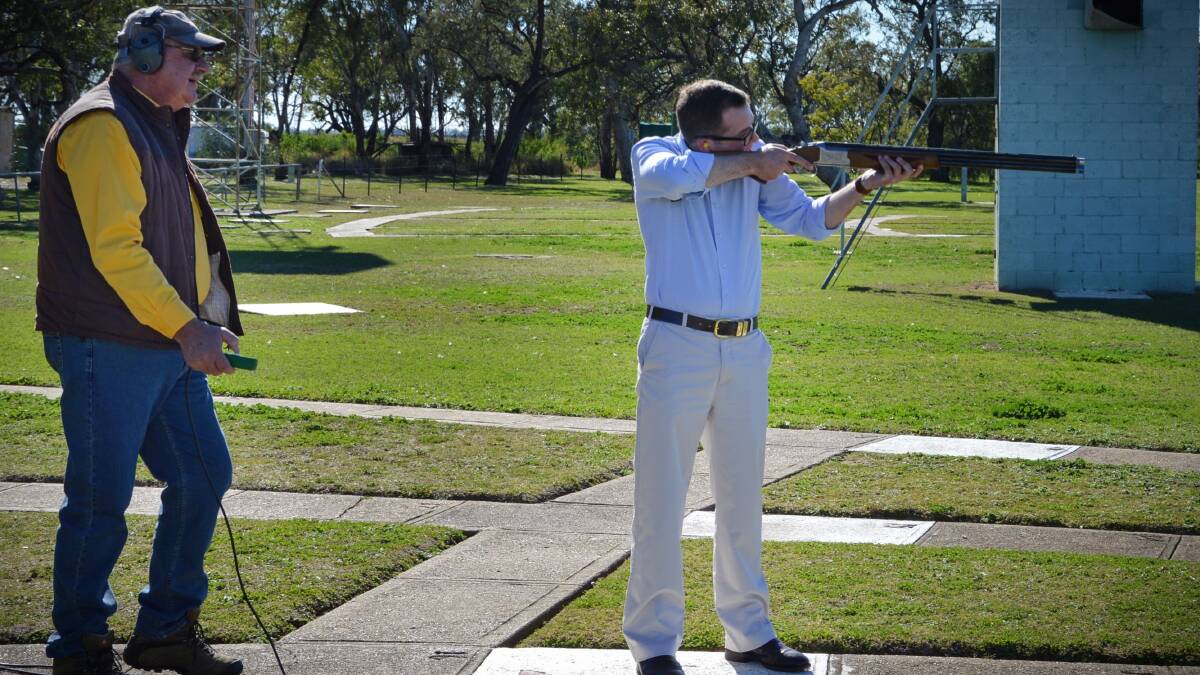 ON TARGET: Gun club treasurer Terry Haynes fires targets for Adam Marshall during the MP’s visit to the Moree club.