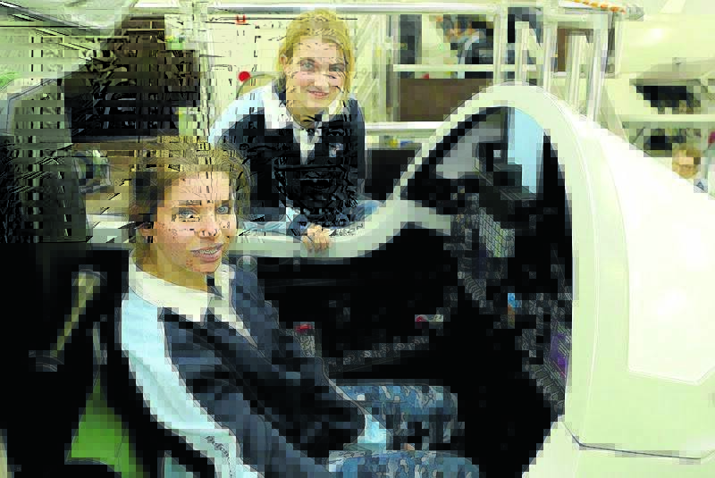 GIRL POWER: O’Connor Catholic College students Georgia Sawyer and Laura Hooper had a hands-on experience at the Royal Australian Air Force camp.