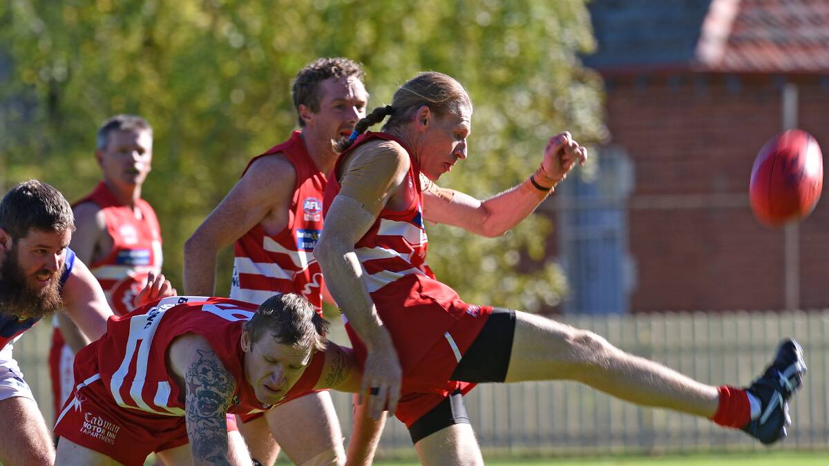 Dean Finlay kicks the Swans out of trouble against Gunnedah Bulldogs in a recent TAFL clash. He plays his 250th game for the Swans on Saturday when the club celebrates a 10 year-reunion of its last TAFL premiership win.  Photo: Gareth Gardner 140516GGD03