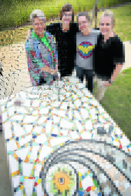 MARVELLOUS MOSAIC: Four of the five main artists responsible for the mosaic bench at The Youthie – from left, Jodie Herden, Emma Stilts, Joanne Stead and Karen Balsar. 080416GOB02