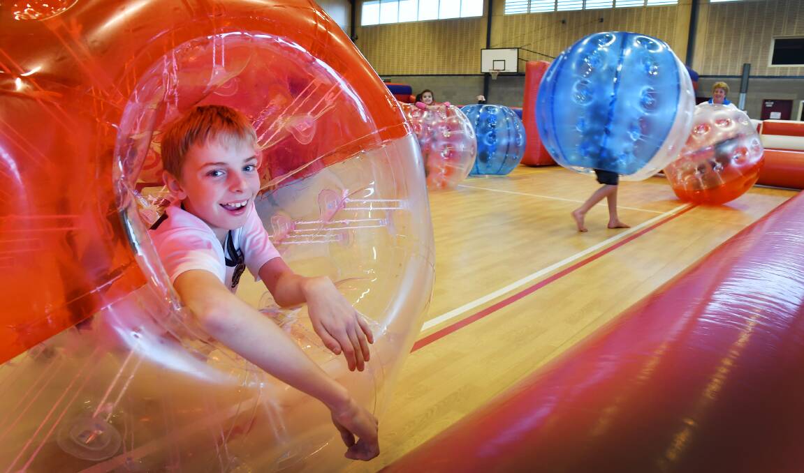BUBBLEBOY: Brayden Boonstra, 11, plays bubble soccer at Calrossy’s William Cowper Hall. Photo: Barry Smith 120716BSC01