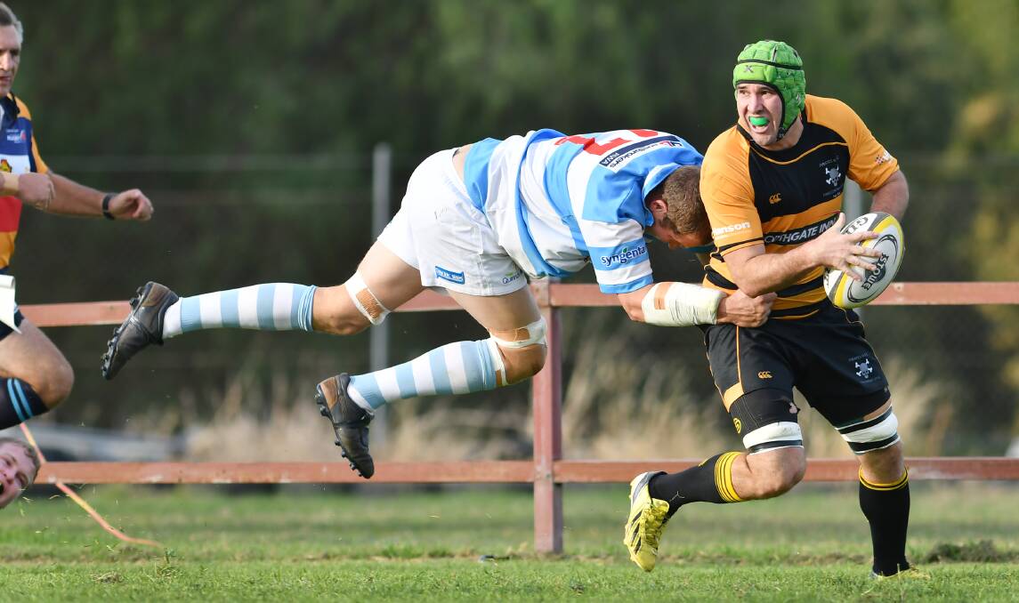Quirindi coach Nick Rees gets airborne to try to stop Pirates number eight Conrad Starr. Photo: Barry Smith 210516BSF17