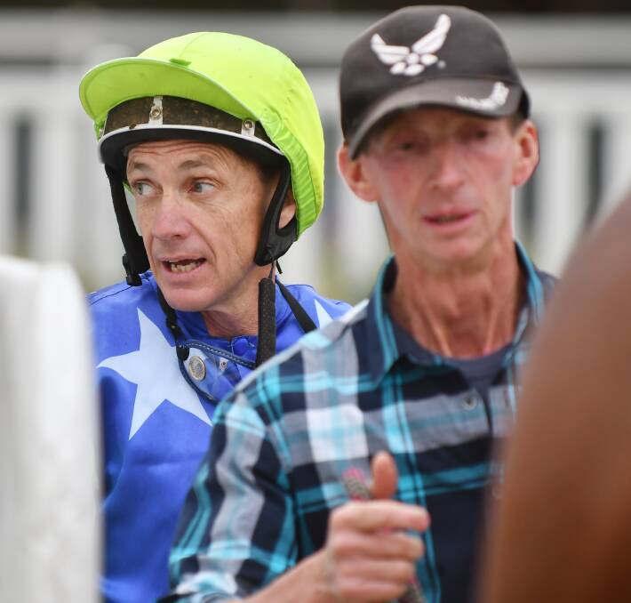 Greg Ryan rode four winners at Tamworth last Friday and one at  Wellington on Sunday before  riding at Quirindi today. Dubbo trainer Dar Lunn, who prepared Playing Game to win at Tamworth, is in the foreground. Photo: Barry Smith 030616BSC25