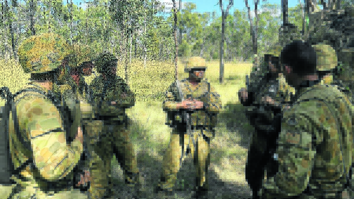 TALKING TACTICS: V11F going through mission rehearsal discussions prior to conducting a live-fire convoy escort task with 2nd/14th Light Horse Regiment (Queensland Mounted Infantry), From left Trooper Patrick Wilson, section second-in-command Trooper Casey Flanagan, Trooper Sam Woods, Trooper Matthew Dale, section commander Lance Corporal Liam O’Brien, Trooper Patrick Flanagan and Trooper Samuel Lewis.
