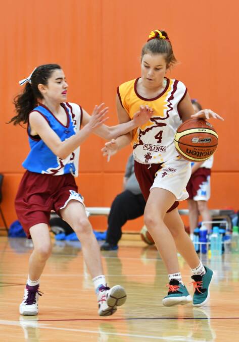 St Edward’s student Mia Kennedy was instrumental in Polding taking out the state 
championships at the Sports Dome yesterday. Here she looks to beat Ruby Brannon in a pool game. Photo: Barry Smith 240516BSB46