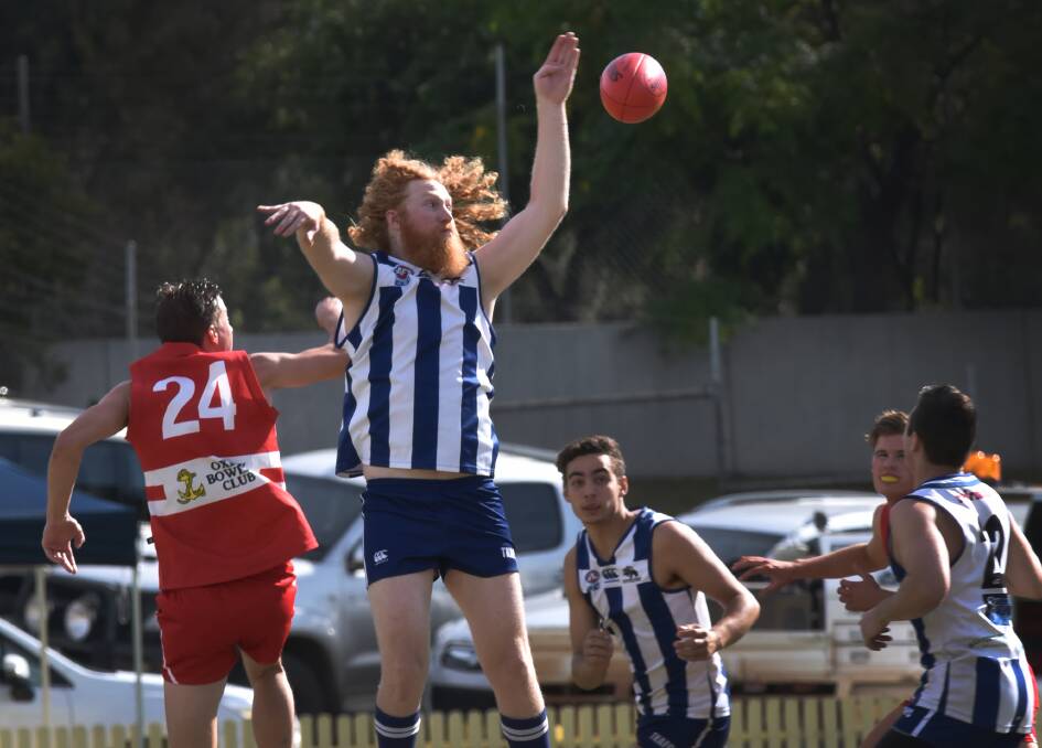 Daniel Ray wins this ball-up against Swans ruckman Jack Abbott (24) as teammate Daniel Leon looks on during Saturday’s 119-point thrashing of the Swans. Photo: Geoff O’Neill 070516GOC01