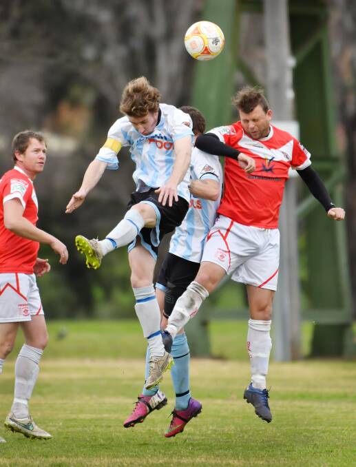 OVA  stalwart Adam Watson (right) vies for this header against Tamworth FC’s Andrew James on Saturday. Watson’s clinical header gave his side a 2-nil lead on the way to a 4-1 win. Teammate Glenn McKnight (left) looks on. Photo: Barry Smith 160716BSF01