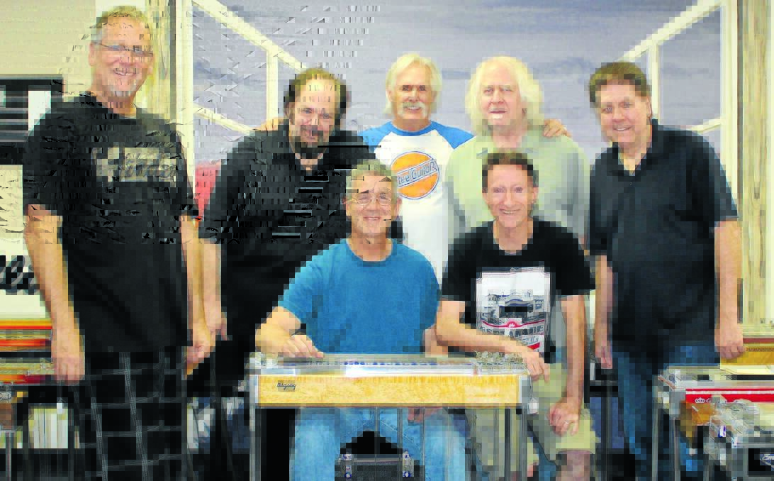 STEEL HEAVEN: Lawrie Minson was in “steel guitar heaven” when he got to spend some time with, from left, Kevin Ryan, Harry Orlove, store owner Jim Palenscar, Skip Edwards, Jay Dee Maness and Peter Freiberger, front, at Steel Guitars of North County.