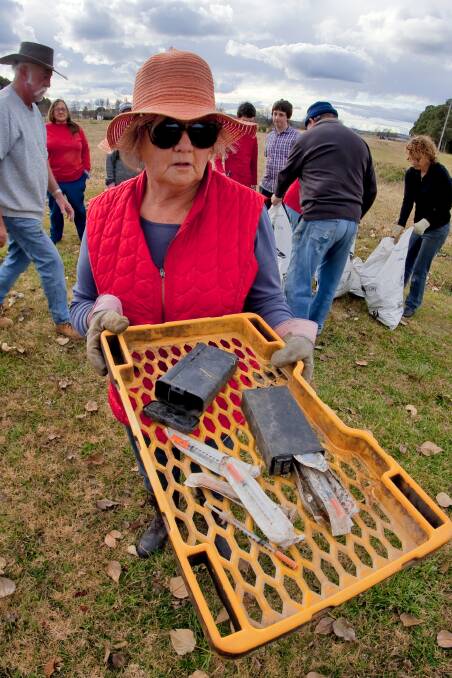 Carol Sparks with syringes, needles, and drug paraphernalia found along the banks of the Rocky Ponds Creek behind the rugby oval