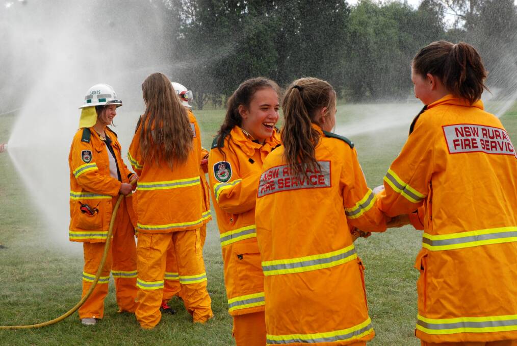 The Tenterfield High School cadets use hoses to simulate fighting a fire.