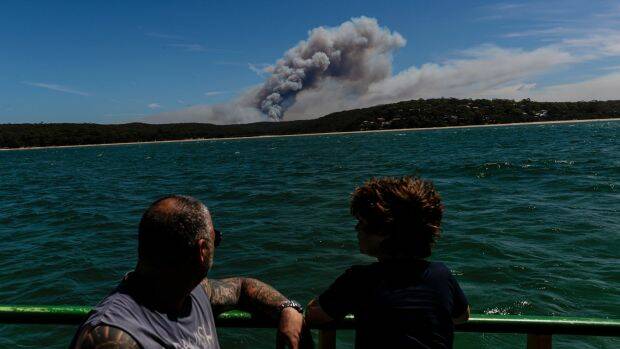 A bushfire burning in the Royal National Park is seen from the Cronulla-to-Bundeena Ferry. Photo: Brook Mitchell