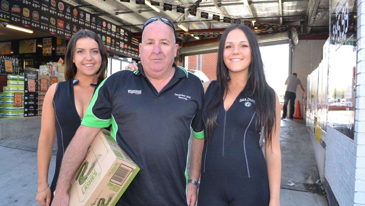 BUSY WEEK: Georgie Holden, left, Kandos race fan Colin Cole and Sophie Gould at the Knickerbocker Hotel drive-through bottle shop, which was doing a roaring trade yesterday. Photo: BRIAN WOOD 	100915knicker