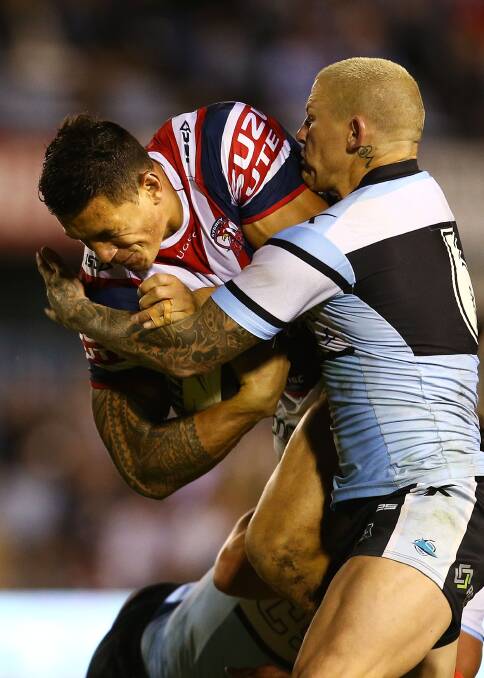 Sonny Bill Williams of the Roosters is tackled by Todd Carney of the Sharks during the round seven NRL match between the Cronulla-Sutherland Sharks and the Sydney Roosters at Remondis Stadium on April 19, 2014 in Sydney, Australia. Photo: Mark Nolan/Getty Images.