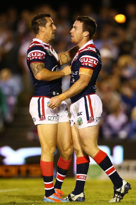  James Maloney of the Roosters is congratulated after scoring during the round seven NRL match between the Cronulla-Sutherland Sharks and the Sydney Roosters at Remondis Stadium on April 19, 2014 in Sydney, Australia. Photo: Mark Nolan/Getty Images.