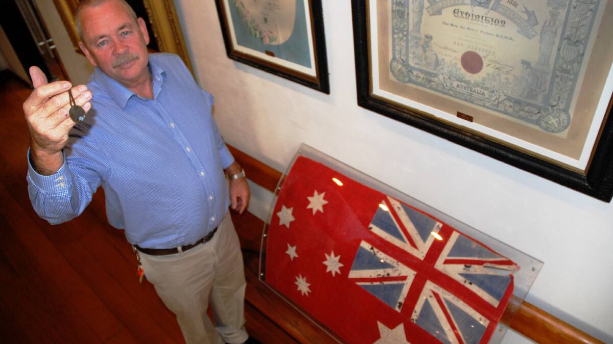 HISTORY: Tenterfield Shire Council Cultural and Business Services Officer Harry Bolton shows off items that will be on display at the exhibition. One, is believed to be the dog tag worn by Harry ‘Breaker’ Morant at his execution, the other, possibly the oldest Australian flag in existence. 