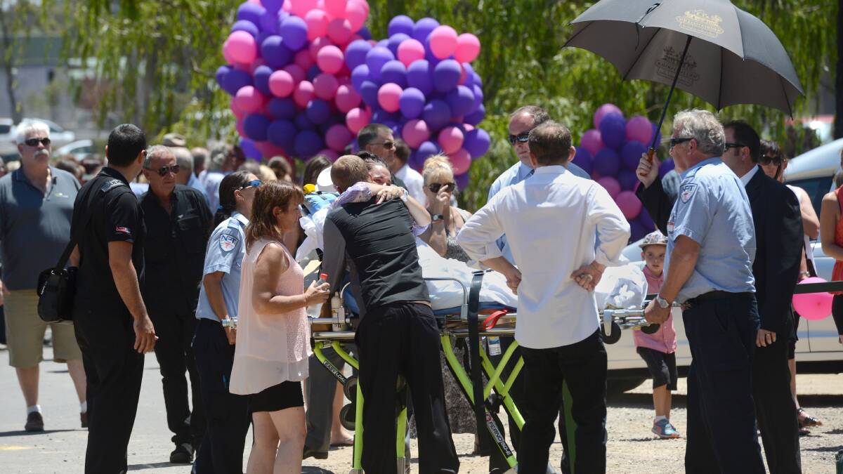 LOVED: Patiya's mother Kristy Thomson is comforted by loved ones. Pictures: JIM ALDERSEY.