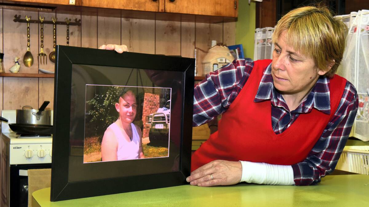 MYSTERY: Lillian Watkins with a picture of her missing son Christopher. Picture: NEIL RICHARDSON