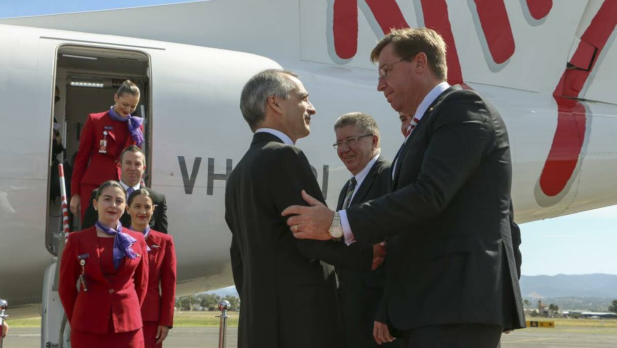 Virgin Airlines lands in Tamworth on Thursday March 5, with CEO John Borghetti, left, welcomed to Tamworth airport by the mayor Col Murray, centre, and deputy Premier Troy Grant, right.