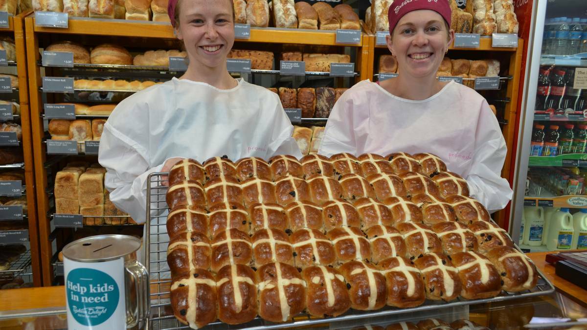 FROM THE OVEN: Stefanie Nelson, left and Amie Campbell with some of their hot cross buns. Photo: The Armidale Express