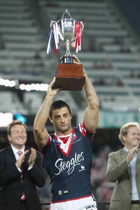 Anthony Minichiello holds the World Club Challenge cup aloft after defeating Wigan Warriors at Allianz Stadium. Picture: Anthony Johnson