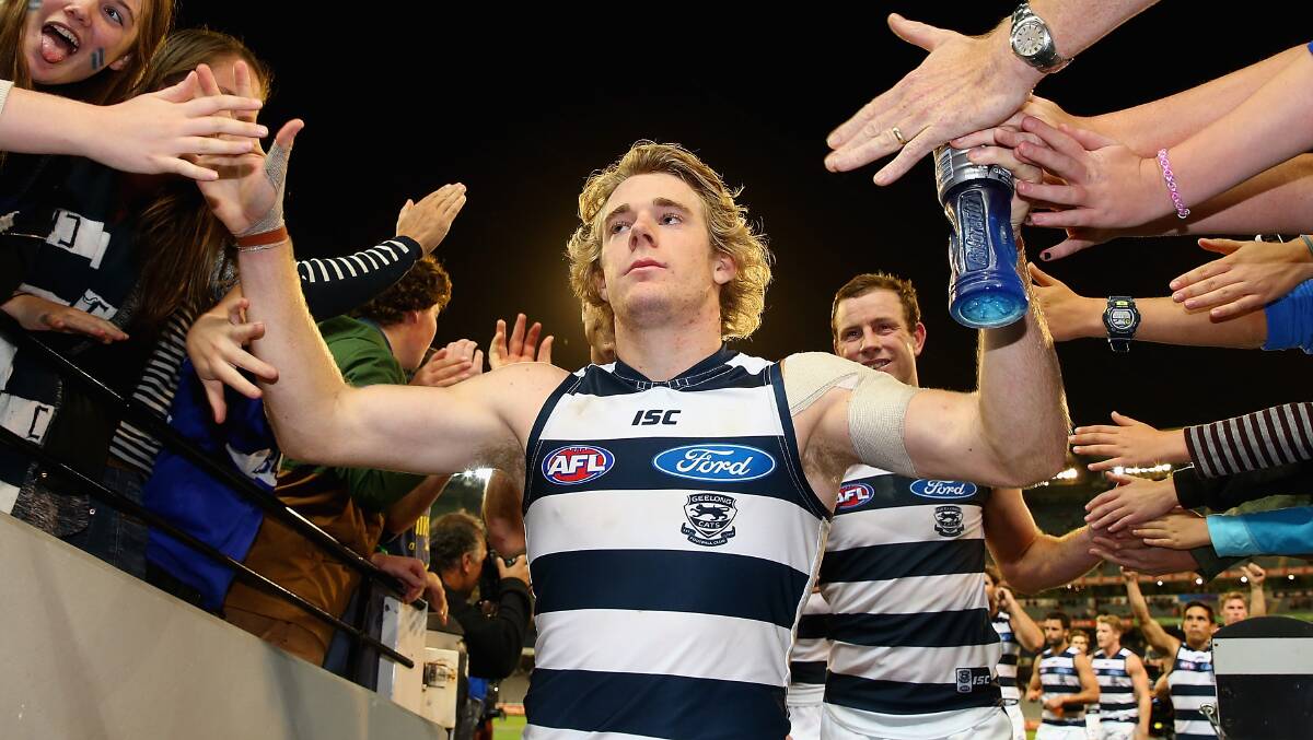 Cameron Guthrie of the Cats high fives fans after winning the round three at the MCG. Geelong ran out 87 points to Collingwood's 76. Picture: Getty Images