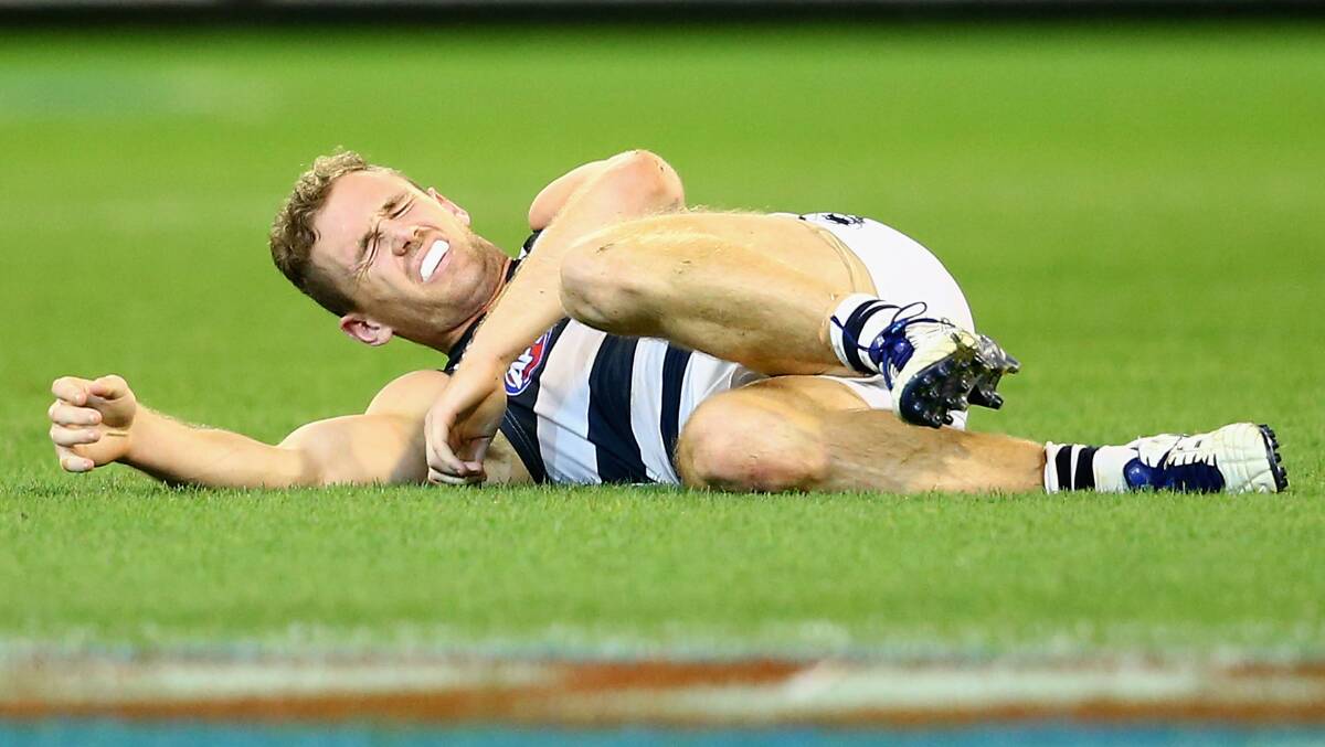 Joel Selwood of the Cats lays on the ground after taking a heavy hit to the head at the MCG. Geelong ran out 87 points to Collingwood's 76. Picture: Getty Images