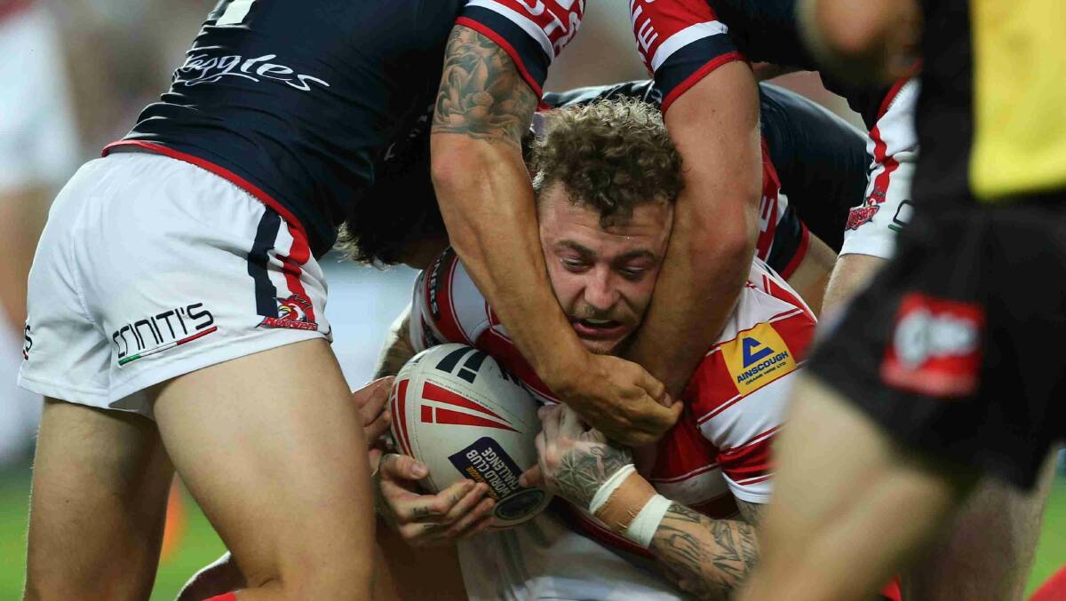 Josh Charnley is swallowed up by Roosters defence in the World Club Challenge game against Wigan Warriors at Allianz Stadium. Picture: Anthony Johnson