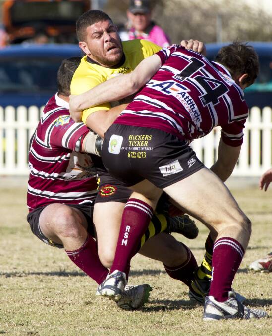Moree Boomerangs’ Mundarra Weldon is wrapped up by the Inverell defence. 
Photo: John Hamilton