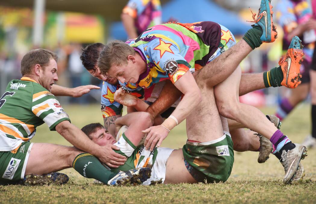 Kootingal’s Nathan Hamlin (back) and Ryan Martin combine to slam Walcha centre Lee Harrison into the Kooty Oval turf with five-eighth Jason Latham (left) trying to lend his teammate a hand. Photo: Barry Smith 250715BSD25
