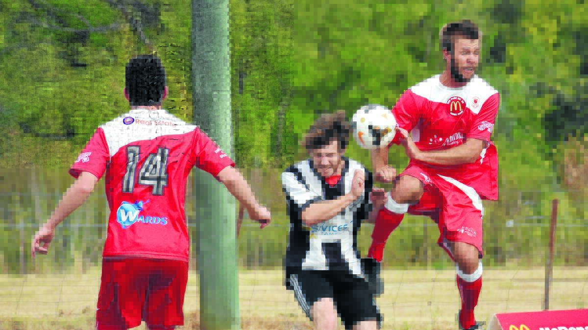 North Armidale's Jason Boundie goes above North Companions James Russ on Saturday with Liam Georkas in defence as the Redmen crushed the home side to coninue a perfect start to the Premier League season. Photo: Geoff O'Neill 090416GOC10