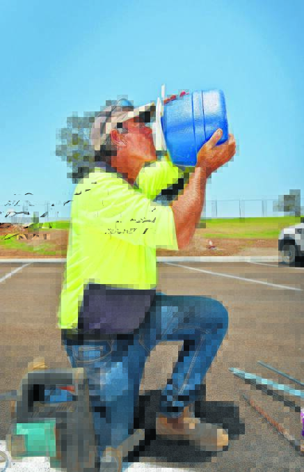 THIRSTY WORK: Glenn Wiltshire was staying well hydrated while linemarking at the new regional playground. 201115GOB01