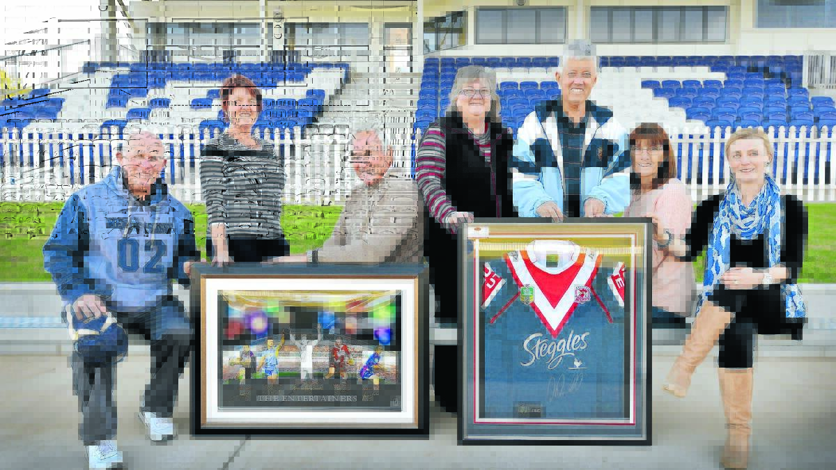 WHAT AM I BID? The Men of League (MOL) have donated two framed collectables for the A Night For Kate fundraiser at Wests this Saturday. Pictured at the presentation were, from left, Kevin Robinson (MOL), Wendy Boreham (Friends of Kate organising committee), Ron Surtees (MOL), Leanne Courtney, Mick and Enfys Galvin and Laura Yeo (FOK). Photo: Barry Smith 270715BSE03
